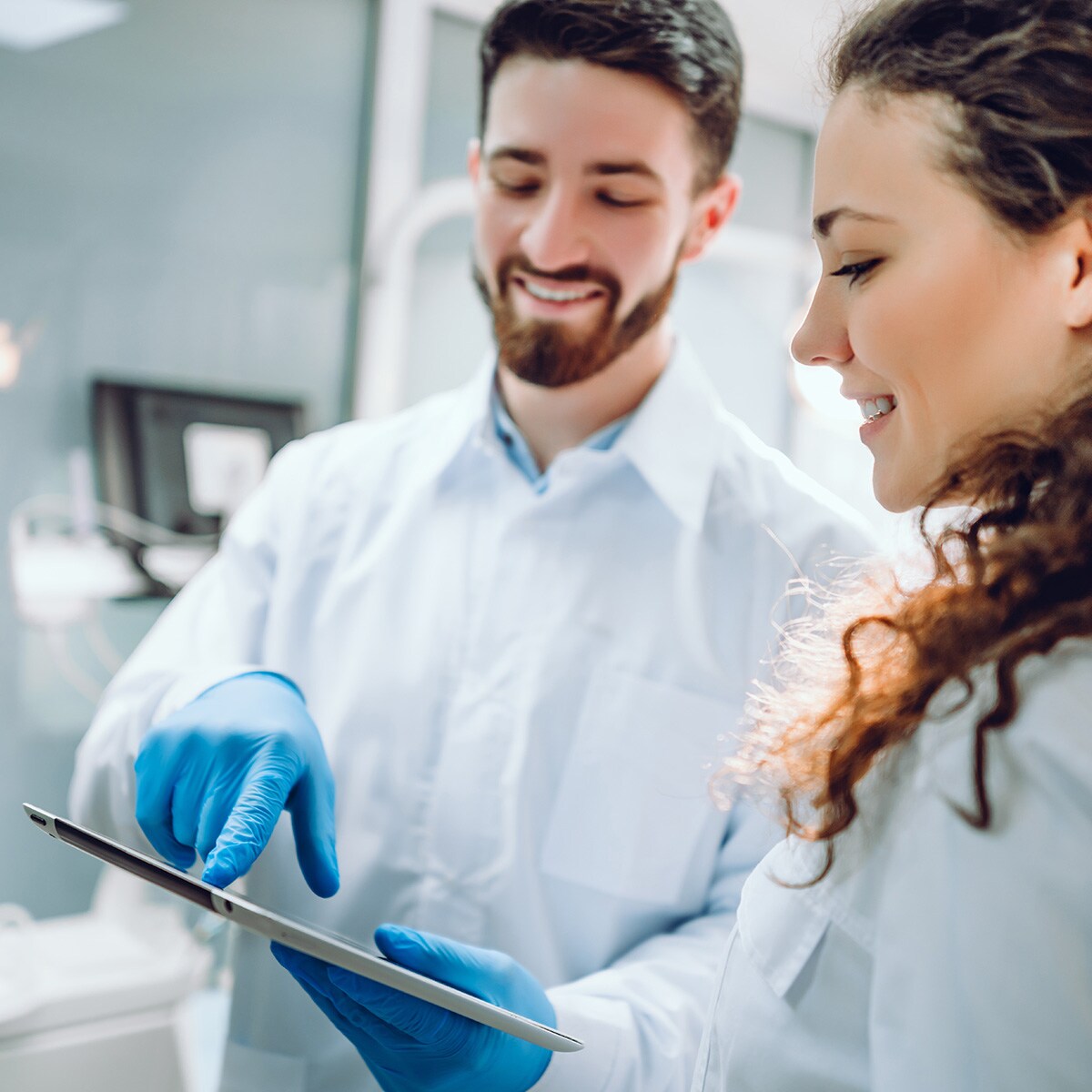 Two dental professionals browsing deals on henryschein.com.